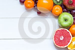 Fresh fruits on wooden boards frame background