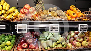Fresh fruits in wicker baskets on shelf of supermarket