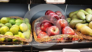 Fresh fruits in wicker baskets on shelf of supermarket