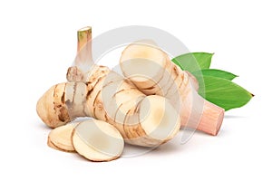 Fresh galangal rhizomes with sliced and green leaf photo