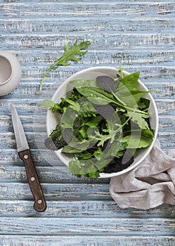 Fresh garden herbs on a blue rustic wooden background