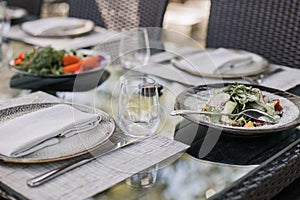 Fresh garden salad on an elegantly set outdoor dining table, perfect for al fresco dining experiences