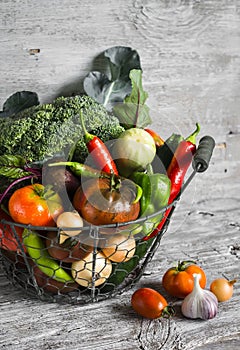 Fresh garden vegetables - broccoli, zucchini, eggplant, peppers, beets, tomatoes, onions, garlic - vintage metal basket