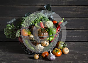 Fresh garden vegetables - broccoli, zucchini, eggplant, peppers, beets, tomatoes, onions, garlic - vintage metal basket