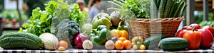 Fresh garden vegetables on checkered tablecloth with basket of herbs