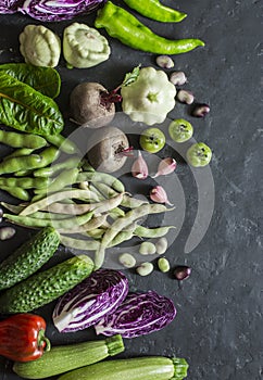 Fresh garden vegetables food background. Red cabbage, zucchini, peppers, beets, beans, squashes, garlic on dark background, top vi