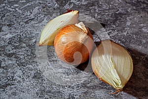 Fresh garlic bulbs and a garlic press on an old wooden board and a burlap backing