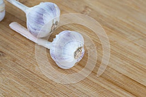Fresh garlic a couple of whole heads on a wooden background close-up