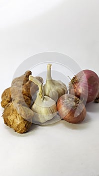 fresh garlic,ginger and onion on a white isolated surface
