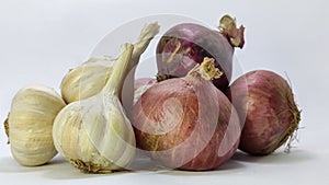 fresh garlic and onion on a white isolated surface