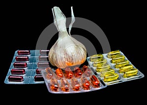 Fresh garlic , pills and vitamins in blister packs