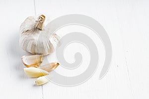 Fresh garlic on the wooden table with white background and copy space