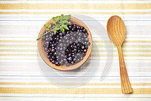 Fresh-gathered bilberries in ceramic plate