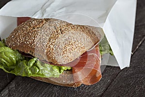 a fresh german bun with ham and salad