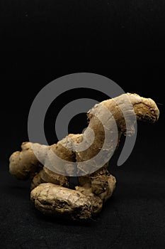 Fresh ginger rhizome isolated on Black background.