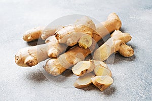 Fresh ginger root on grey background. Copy space