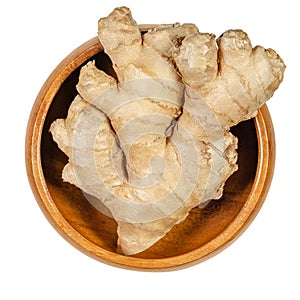 Fresh ginger root, rhizome of Zingiber officinale in wooden bowl