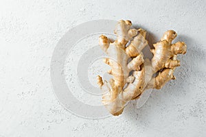 Fresh ginger root on white textured background