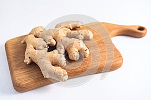 Fresh ginger root on wood board