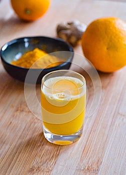 fresh ginger shot with tumeric, orange juice and ginger