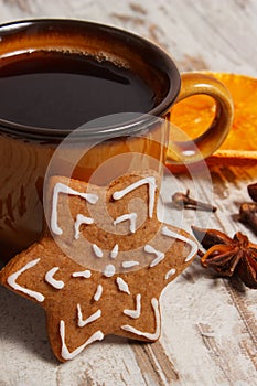 Fresh gingerbread, cup of coffee and spices on old wooden background, christmas time