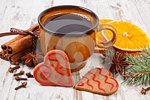 Fresh gingerbread, cup of coffee and spices on old wooden background, christmas time