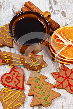 Fresh gingerbread, cup of coffee and spices on old wooden background, christmas time