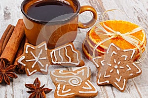 Fresh gingerbread, cup of coffee and spices on old wooden background, christmas time