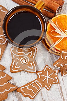 Fresh gingerbread, cup of coffee and spices on old wooden background, christmas time