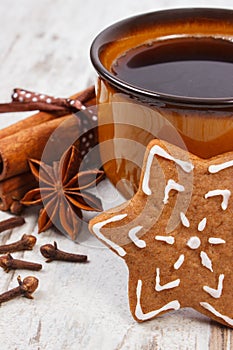 Fresh gingerbread, cup of coffee and spices on old wooden background, christmas time