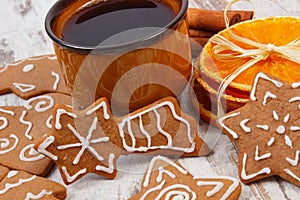 Fresh gingerbread, cup of coffee and spices on old wooden background, christmas time