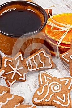 Fresh gingerbread, cup of coffee and spices on old wooden background, christmas time