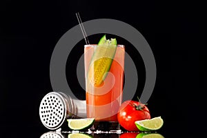 Fresh glass of bloody mary cocktail decorated with lime photo