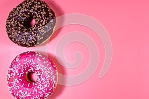 Fresh glazed donuts isolated on a pink background