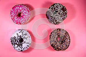 Fresh glazed donuts isolated on a pink background