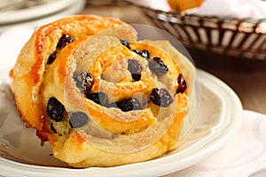 Fresh gluten free sweet swirl bun with raisins