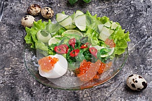 Fresh  gourmet salad with  red  salmon caviar and chuka,  eggs and vegetables. close up.  Protein luxury delicacy  healthy food