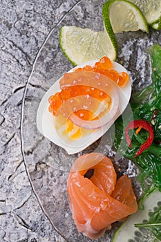 Fresh  gourmet salad with  salmon, caviar, eggs and vegetables.   Protein luxury delicacy  healthy food. beautifull served around