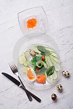 Fresh  gourmet salad with  salmon, caviar, eggs and vegetables. served on white table.   Protein luxury delicacy  healthy food.