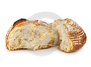 Fresh grain homemade bread cut in half on white.