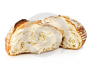 Fresh grain homemade bread cut in half on white.