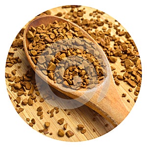 Fresh granules of instant coffee grains, in wooden spoon, on wooden background