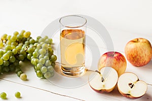 Fresh grape fruits with green leaves isolated on white background. bunch of green grapes and juice in the glass, pitcher