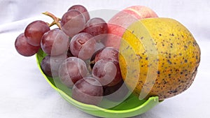 Fresh grape orange and apple or anggur jeruk and apel in indonesian on white background