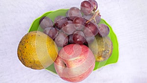 Fresh grape orange and apple or anggur jeruk and apel in indonesian on white background