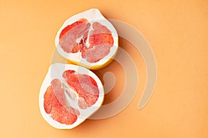 Fresh grapefruit on an orange background, close-up. Sex concept. The concept of women`s health