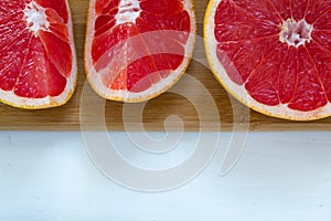 Fresh grapefruit on white boards, food wooden background,