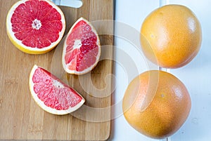 Fresh grapefruit on white boards, food wooden background,