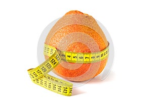 Fresh grapefruit wrapped with measuring tape. The concept of healthy nutrition, weight loss, dietetics