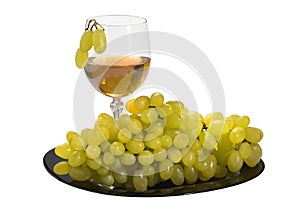 Fresh grapes and glass of grape wine on the white isolated background